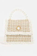 a handbag with pearls and pearls on it