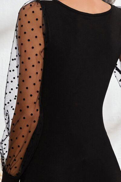 a woman wearing a black dress with polka dots