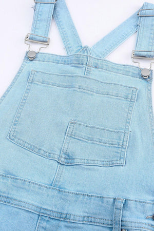 a pair of blue denim overalls with metal straps