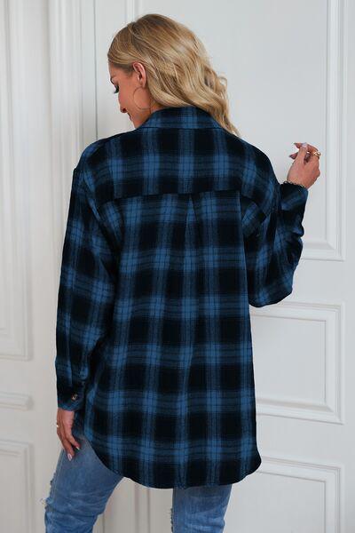 a woman wearing a black and blue plaid shirt