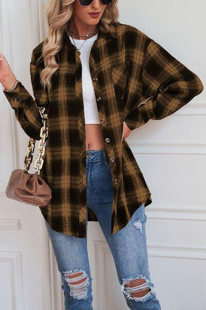 a woman wearing a brown and black plaid shirt