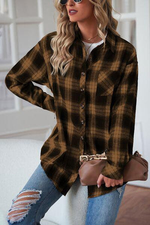 a woman wearing a brown and black plaid shirt