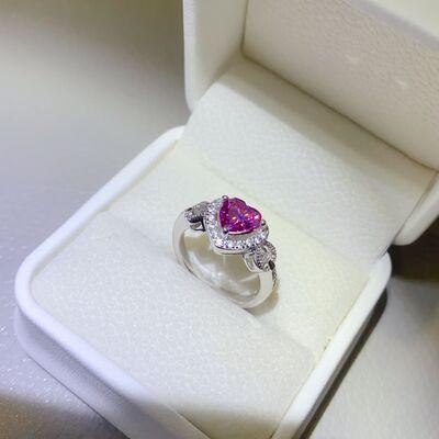 a pink heart shaped diamond ring in a white box