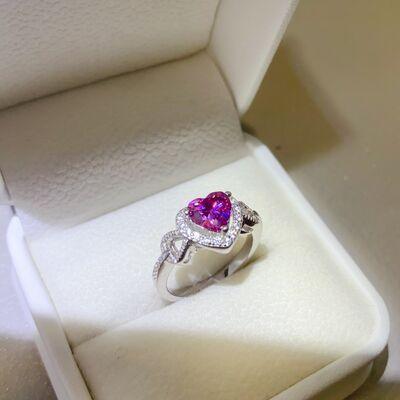 a pink heart shaped diamond ring in a white box