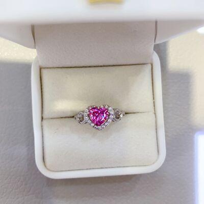 a pink heart shaped diamond ring in a white box