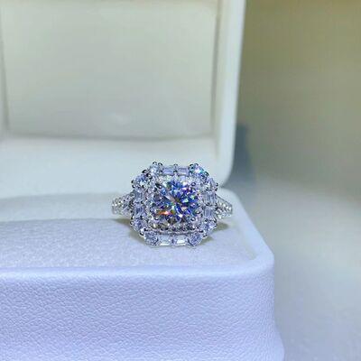 a blue diamond ring sitting on top of a white box