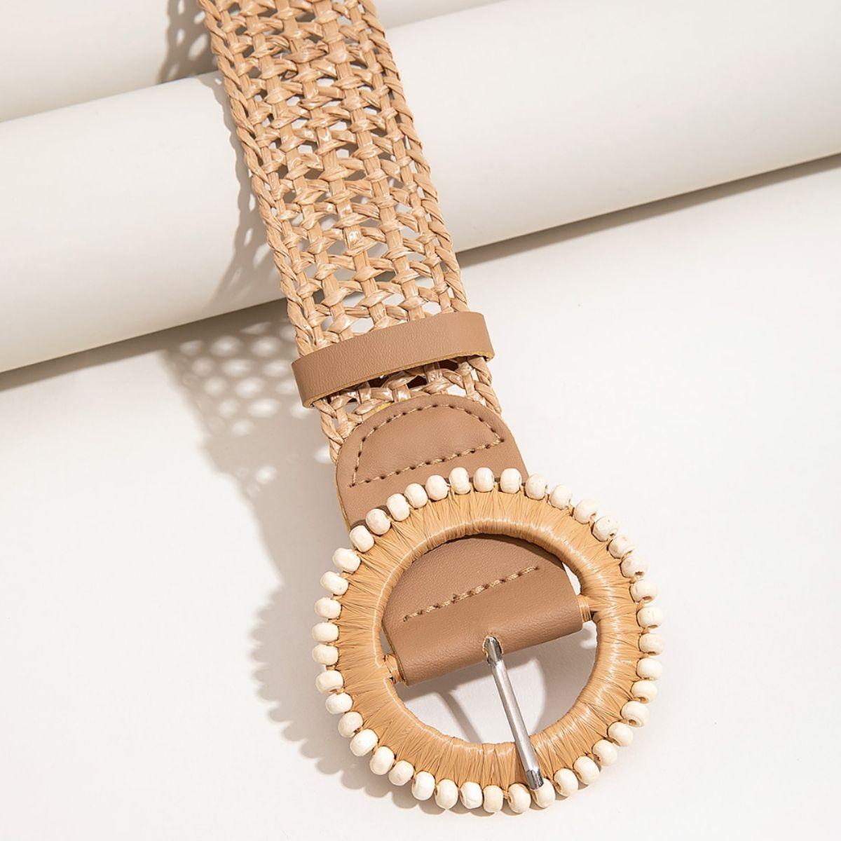 a wooden watch with a leather band and white beads