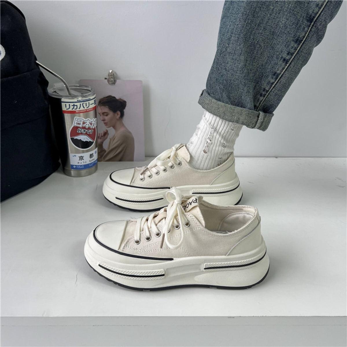 a pair of white shoes sitting on top of a table