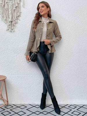 a woman wearing black leather pants and a tan jacket