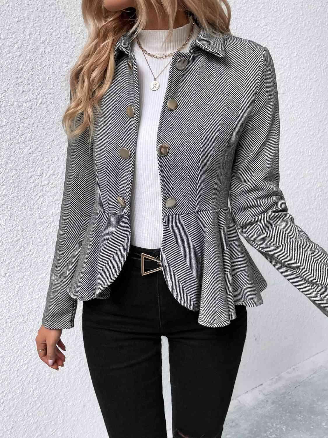 a woman wearing a gray jacket and black jeans