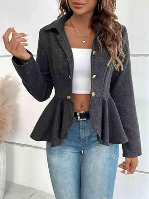 a woman wearing a gray jacket and jeans