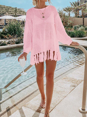 a woman wearing a pink sweater and shorts