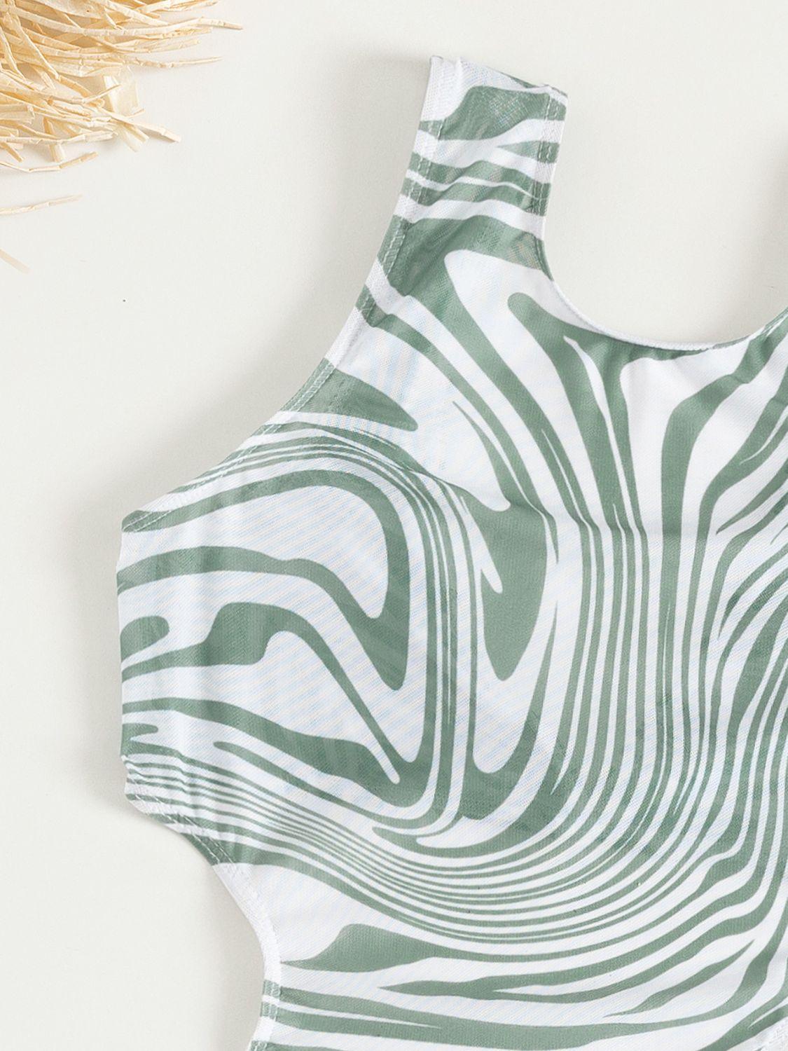 a green and white top with a pattern on it