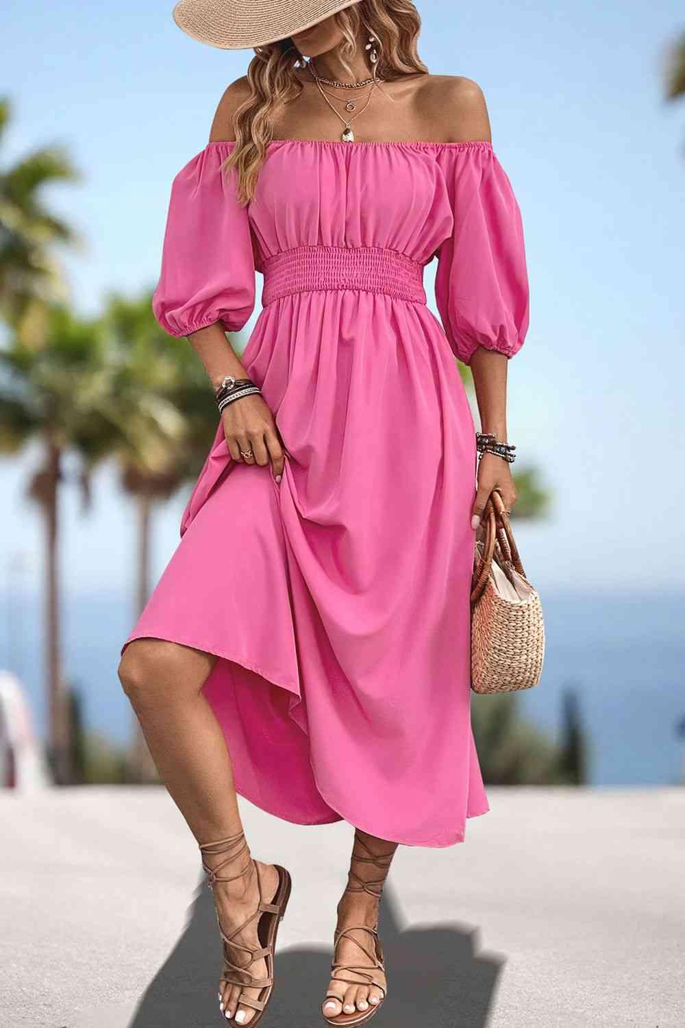 a woman wearing a pink dress and hat