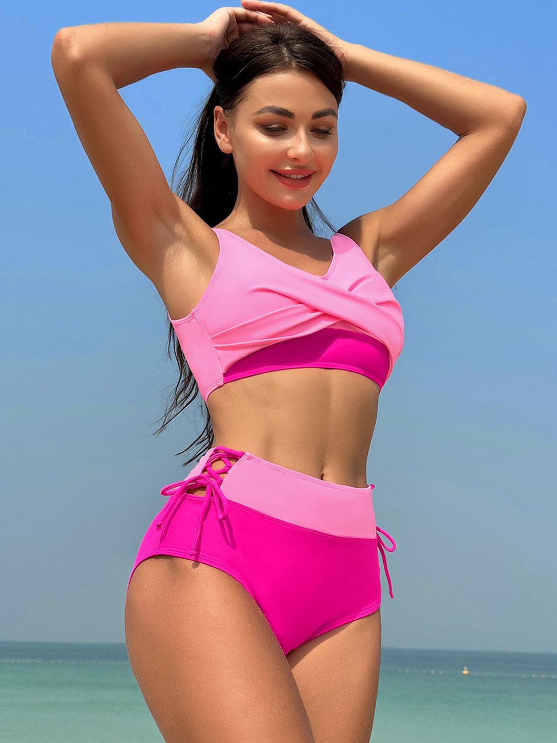 a woman in a pink bikini standing on a beach