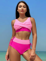 a woman in a pink bikini standing on a beach