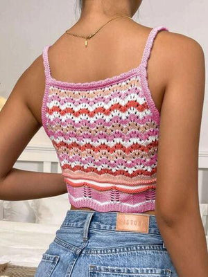 a woman wearing a pink and white knitted top