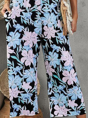 a woman wearing wide legged floral pants