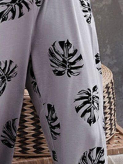 a close up of a person's pants with a plant print