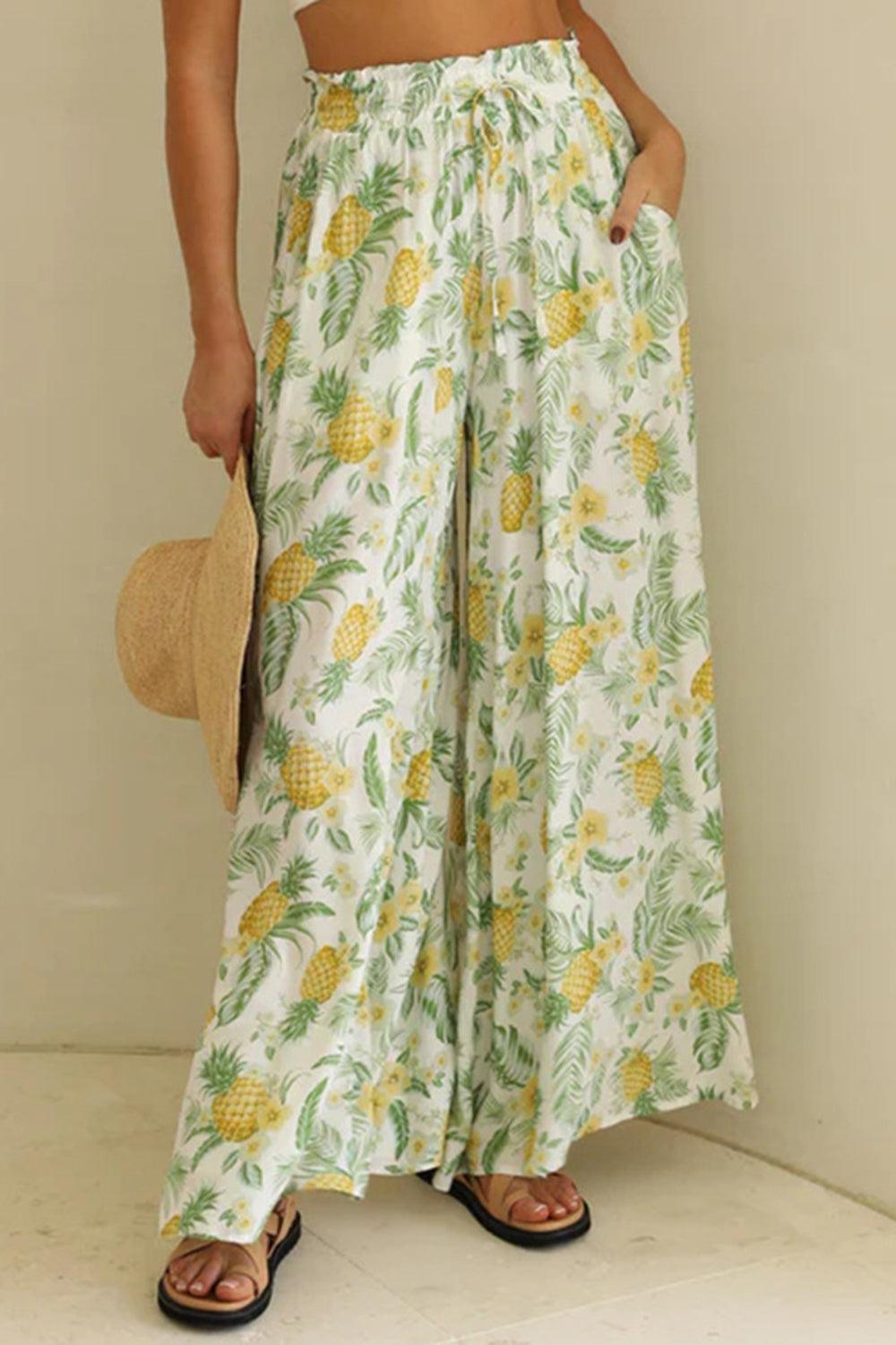 a woman in a crop top and pineapple print pants