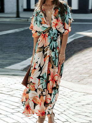 a woman in a floral dress is walking down the street