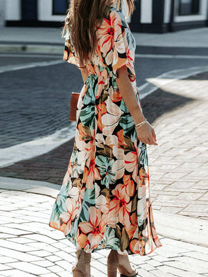 a woman walking down a street wearing a dress