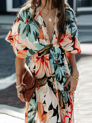 a woman in a floral dress is walking down the street