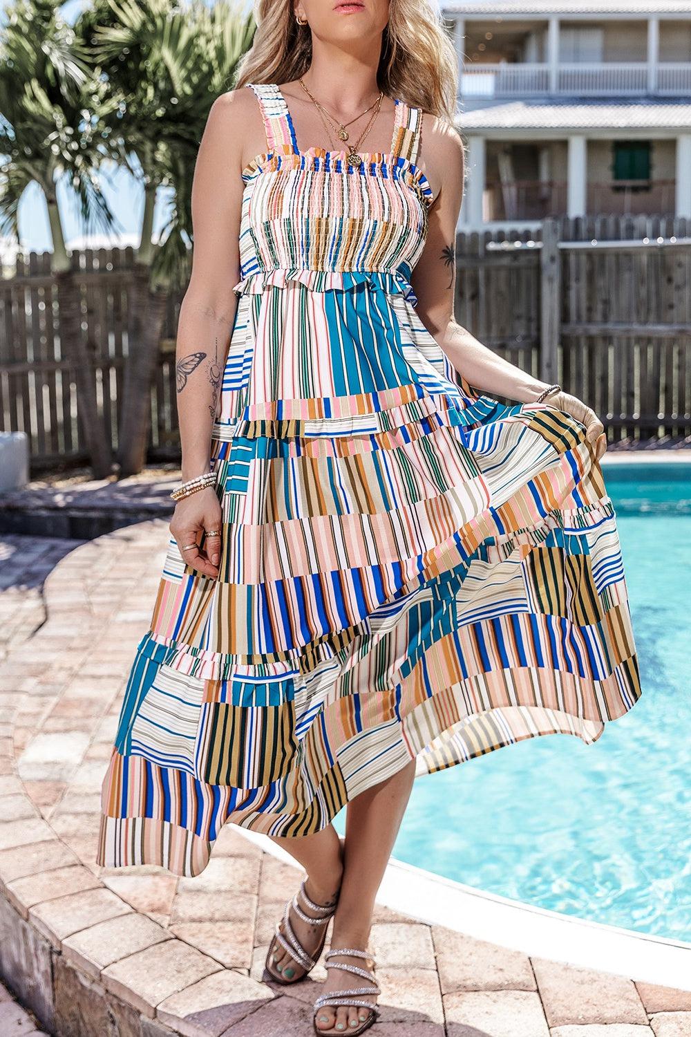 a woman standing next to a pool wearing a dress