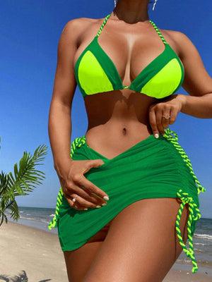 a woman in a green bikini on the beach