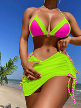 a woman in a neon green bikini on the beach