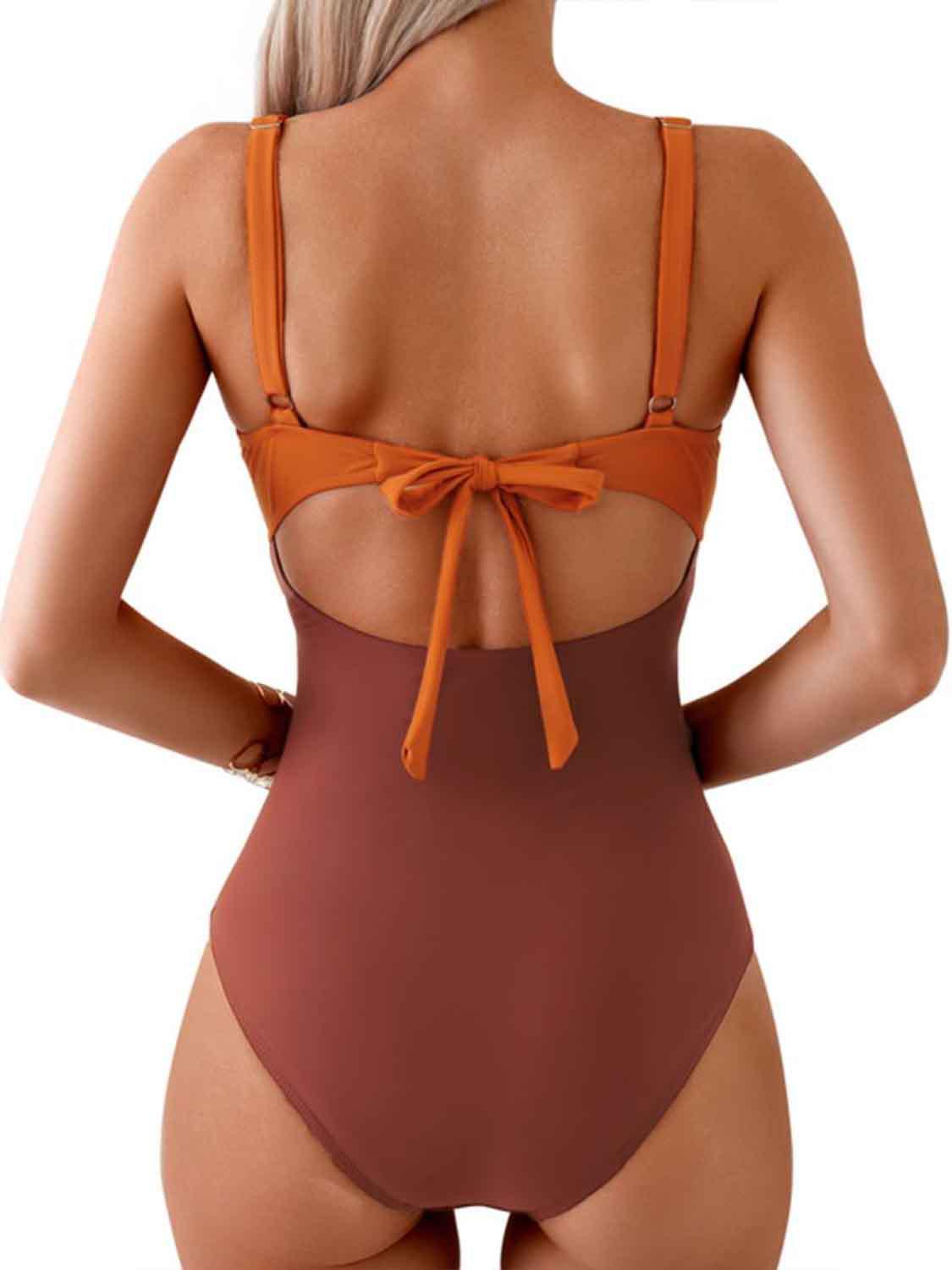 a woman in a brown and brown one piece swimsuit