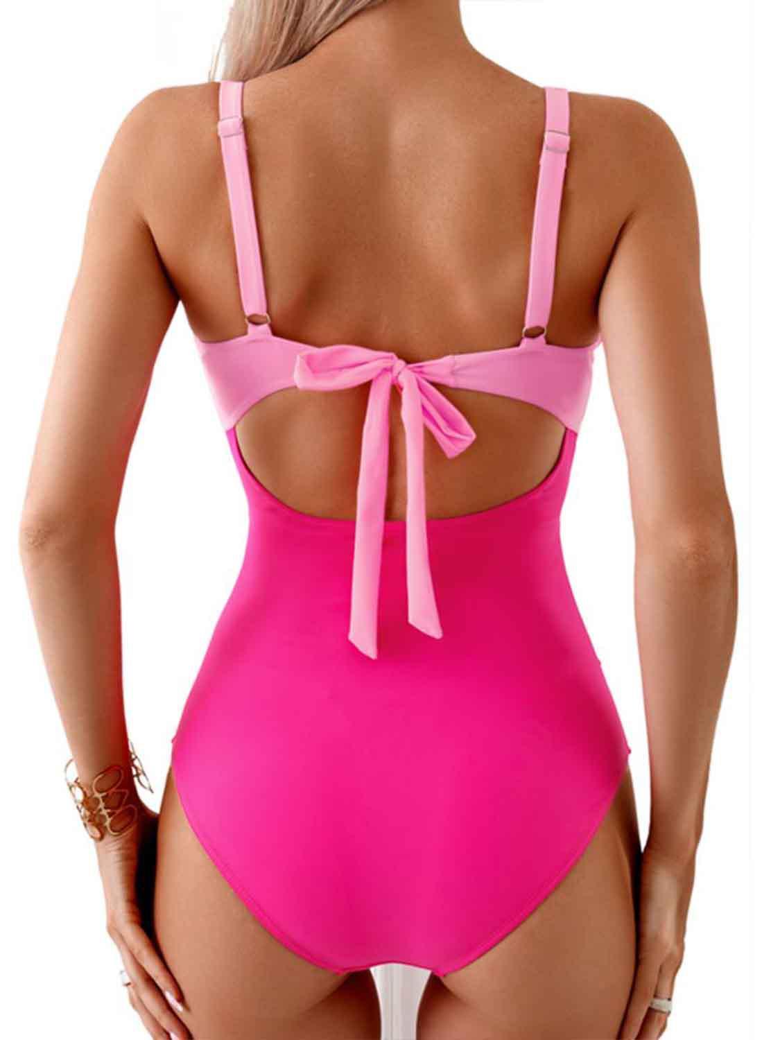 a woman in a pink one piece swimsuit