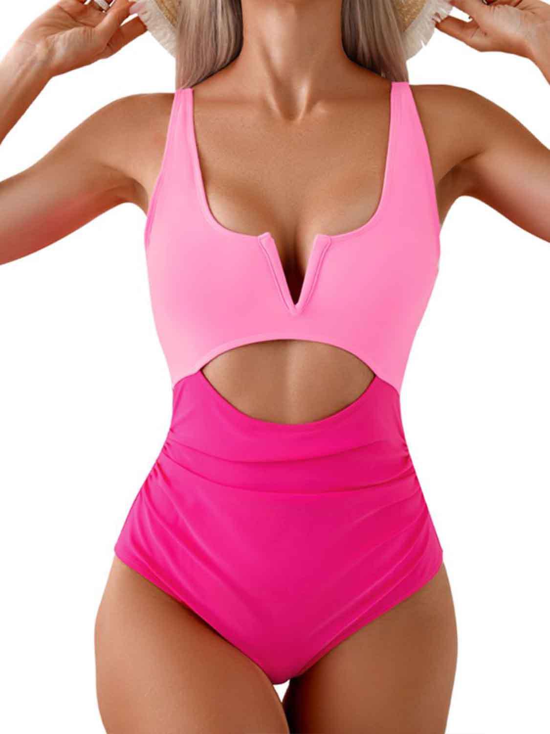 a woman in a pink one piece swimsuit