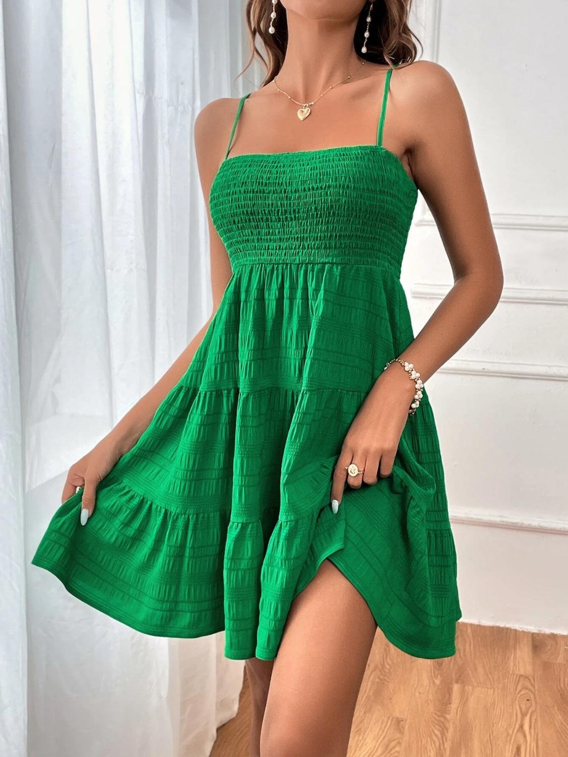 a woman in a green dress posing for a picture