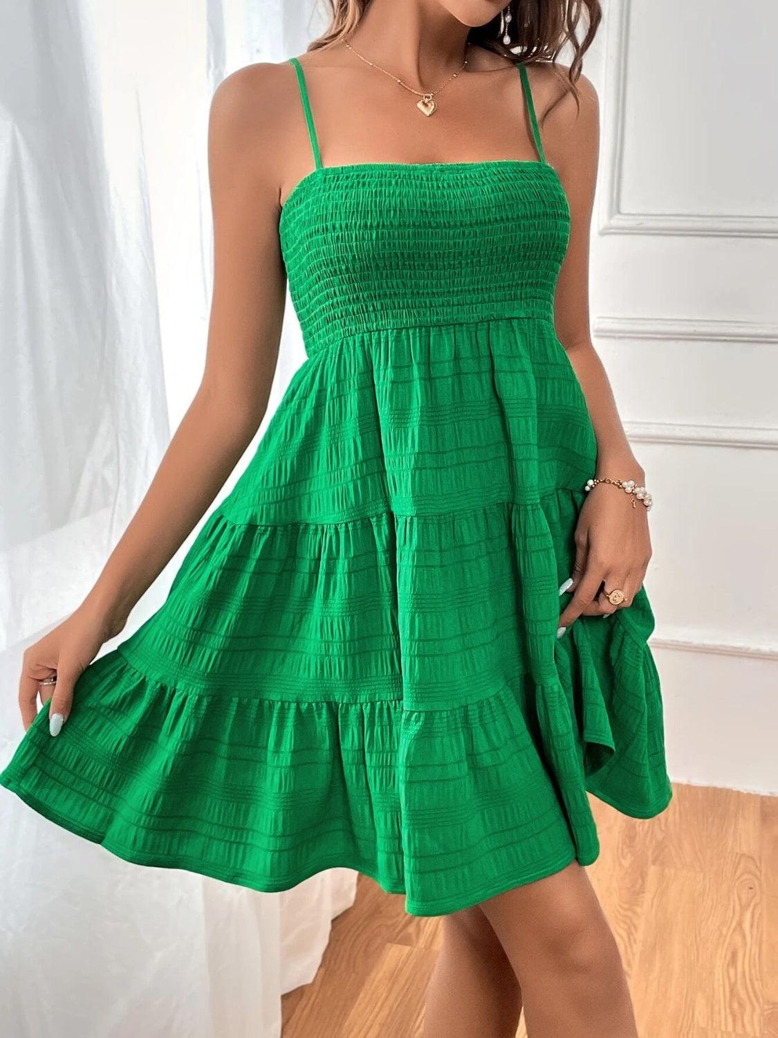 a woman in a green dress posing for a picture