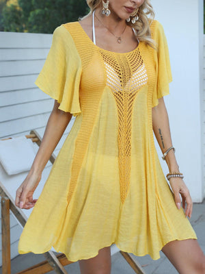 a woman in a yellow dress posing for a picture