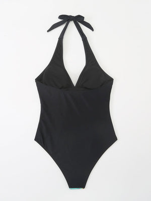 a black one piece swimsuit with a tie at the back