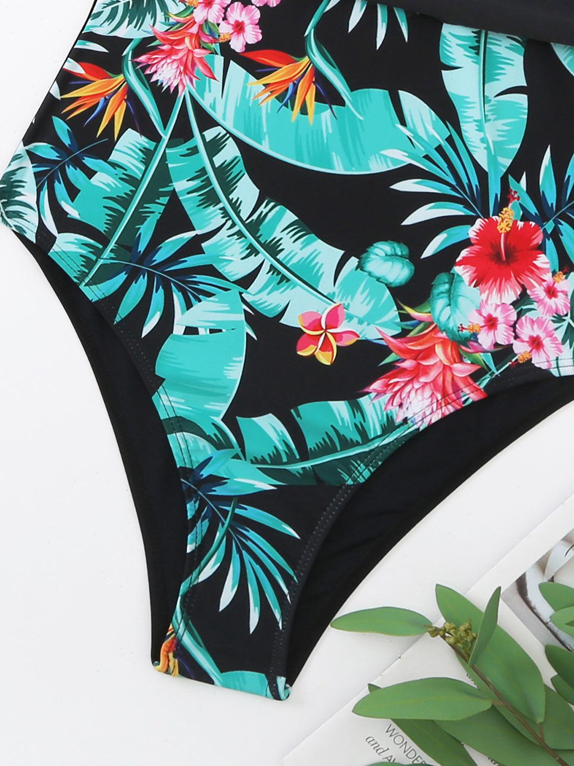 a women's swimsuit with a tropical print