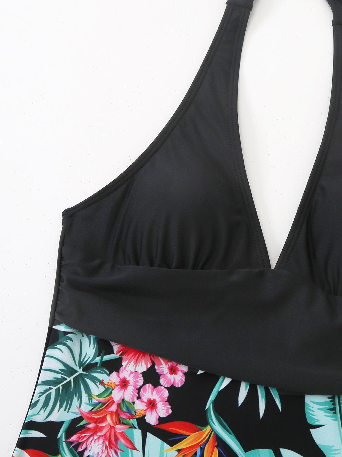 a black bikini top with a tropical print