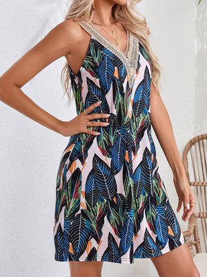 a woman wearing a dress with a tropical print