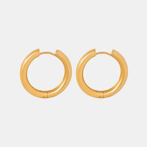 a pair of gold hoop earrings on a white background