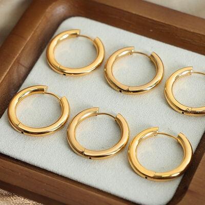 six pairs of gold hoop earrings in a wooden box