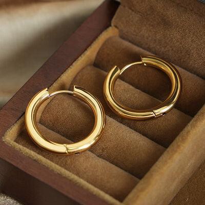 a pair of gold hoop earrings in a box