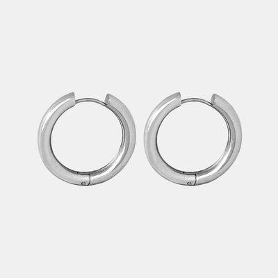 a pair of silver hoop earrings on a white background