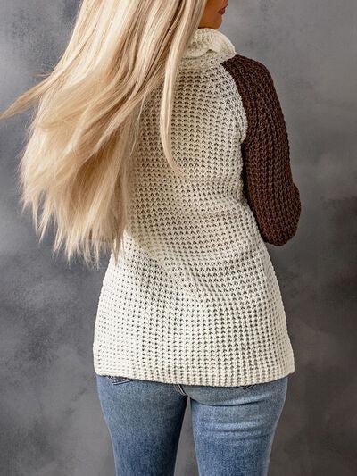 a woman with long blonde hair wearing a sweater