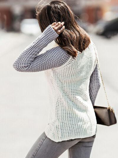 a woman walking down a street holding her hand to her head