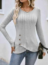 a woman wearing a gray sweater and jeans