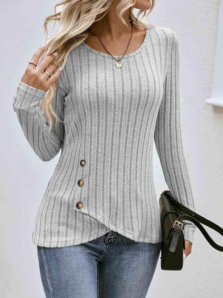 a woman wearing a gray sweater and jeans