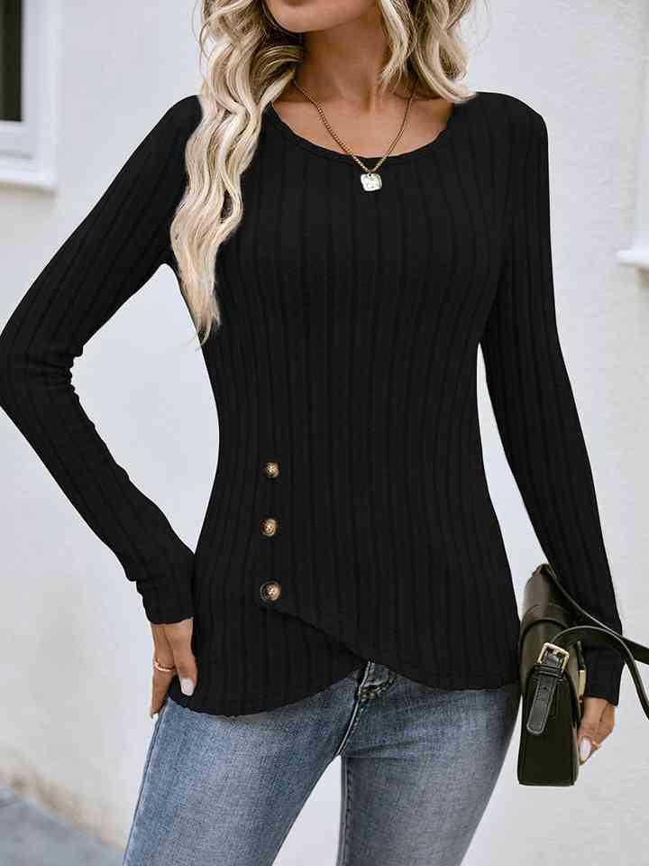 a woman wearing a black sweater and jeans