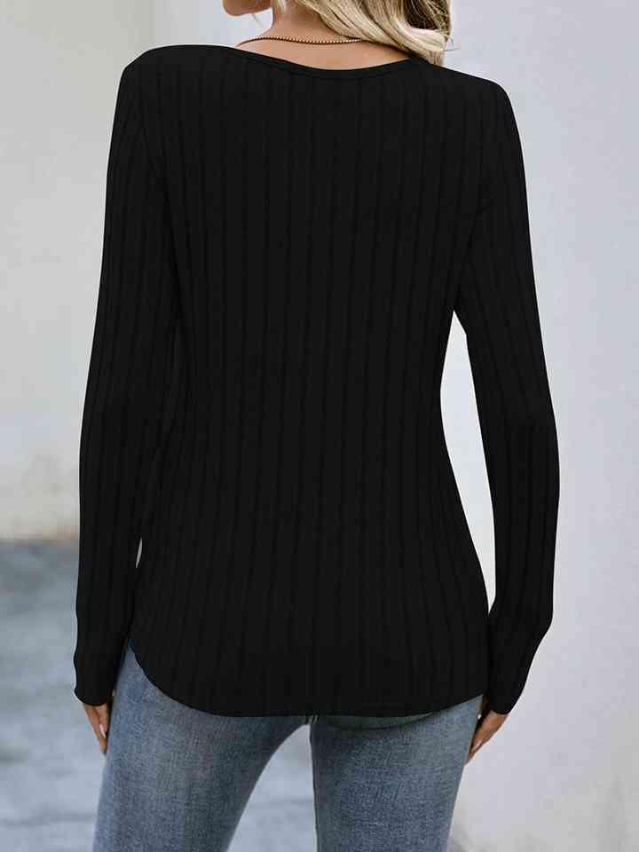 a woman wearing a black sweater and jeans